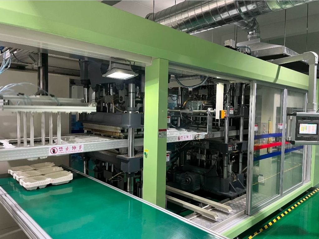 Close-up of JOYI thermoforming line and finished trays